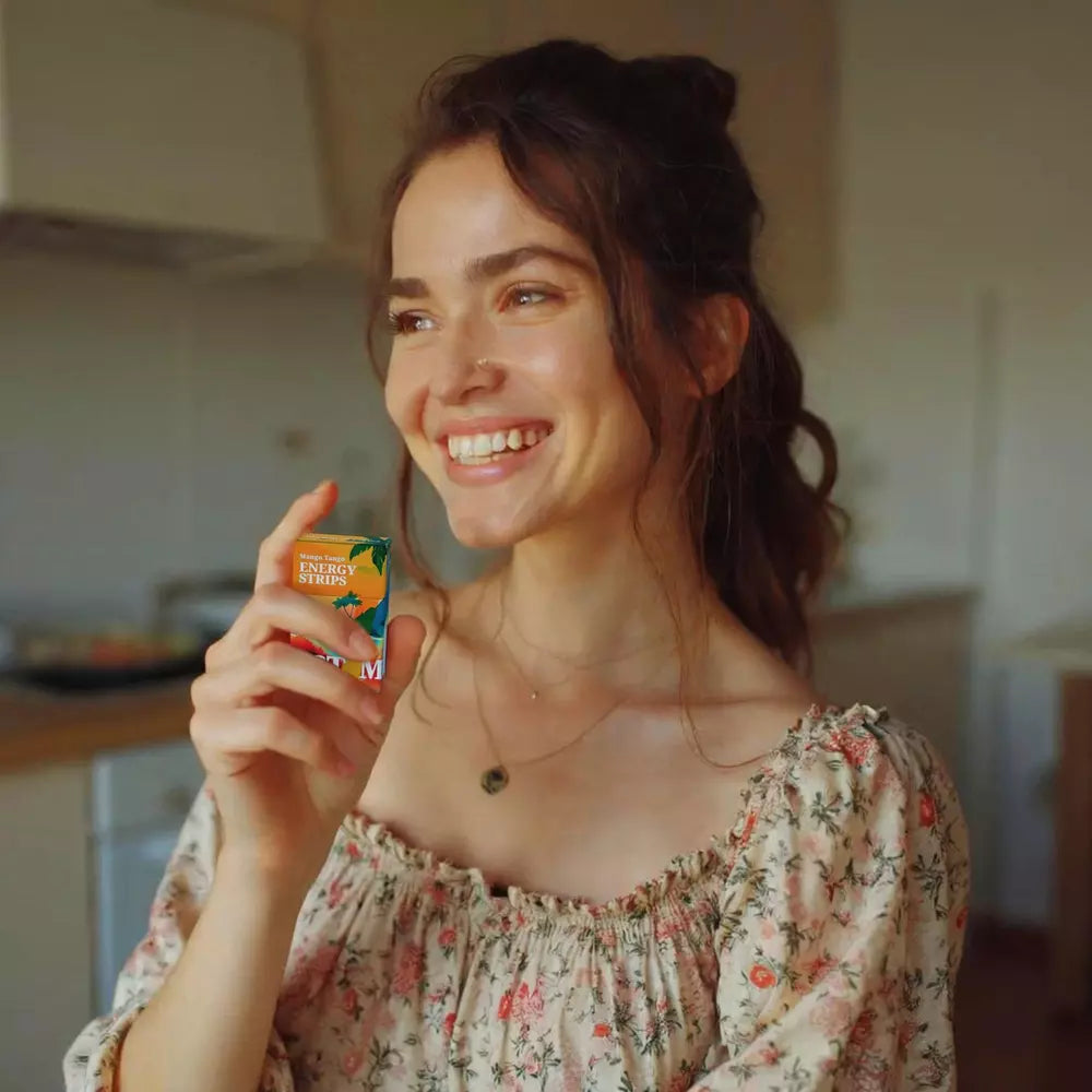 Image of a housewife holding a STIM Mango Tango pack in the kitchen